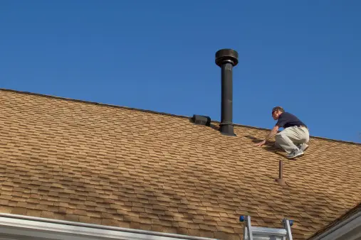 roof inspection on chimney on asphalt shingle roofing